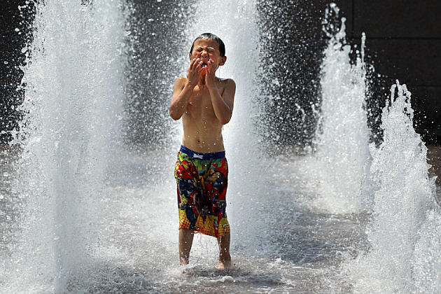 A child cooling off in a fountain.