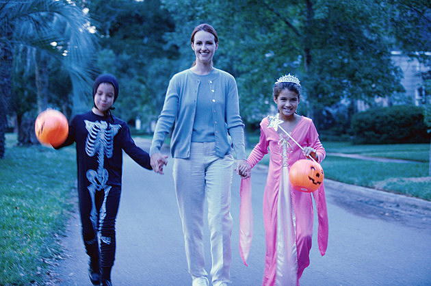 Mother with her son and daughter in Halloween costumes